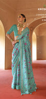 Firozi Teal Blue Silk Saree with Magenta Ikat Accents and Shimmering Gold Zari Border