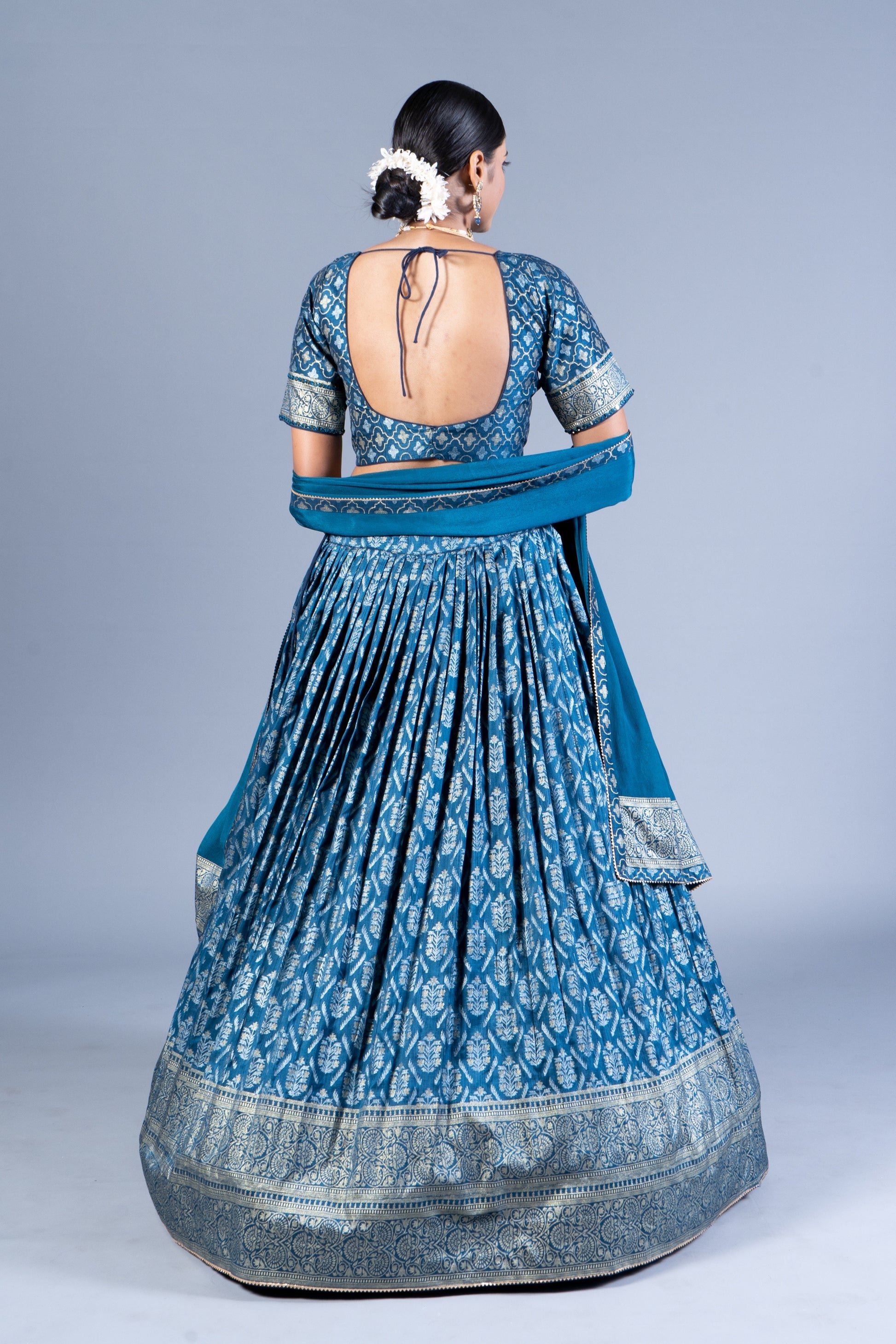 Teal Blue Patola Print Pleated Lehenga Choli with Embroidered Silk Blouse and Zari Border