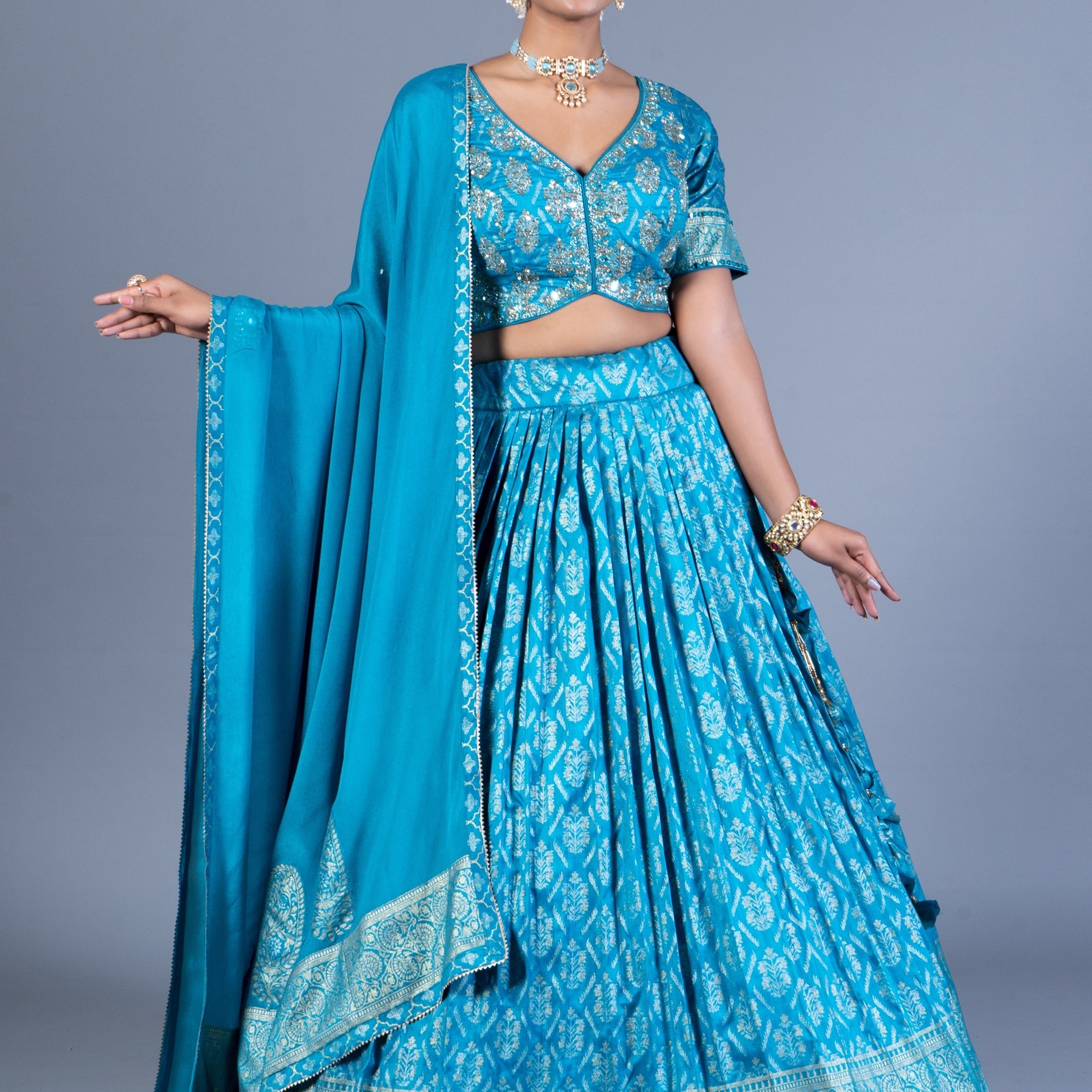Turquoise Blue Patola Print Pleated Lehenga Set with Sequin Embroidered Blouse and Zari Border