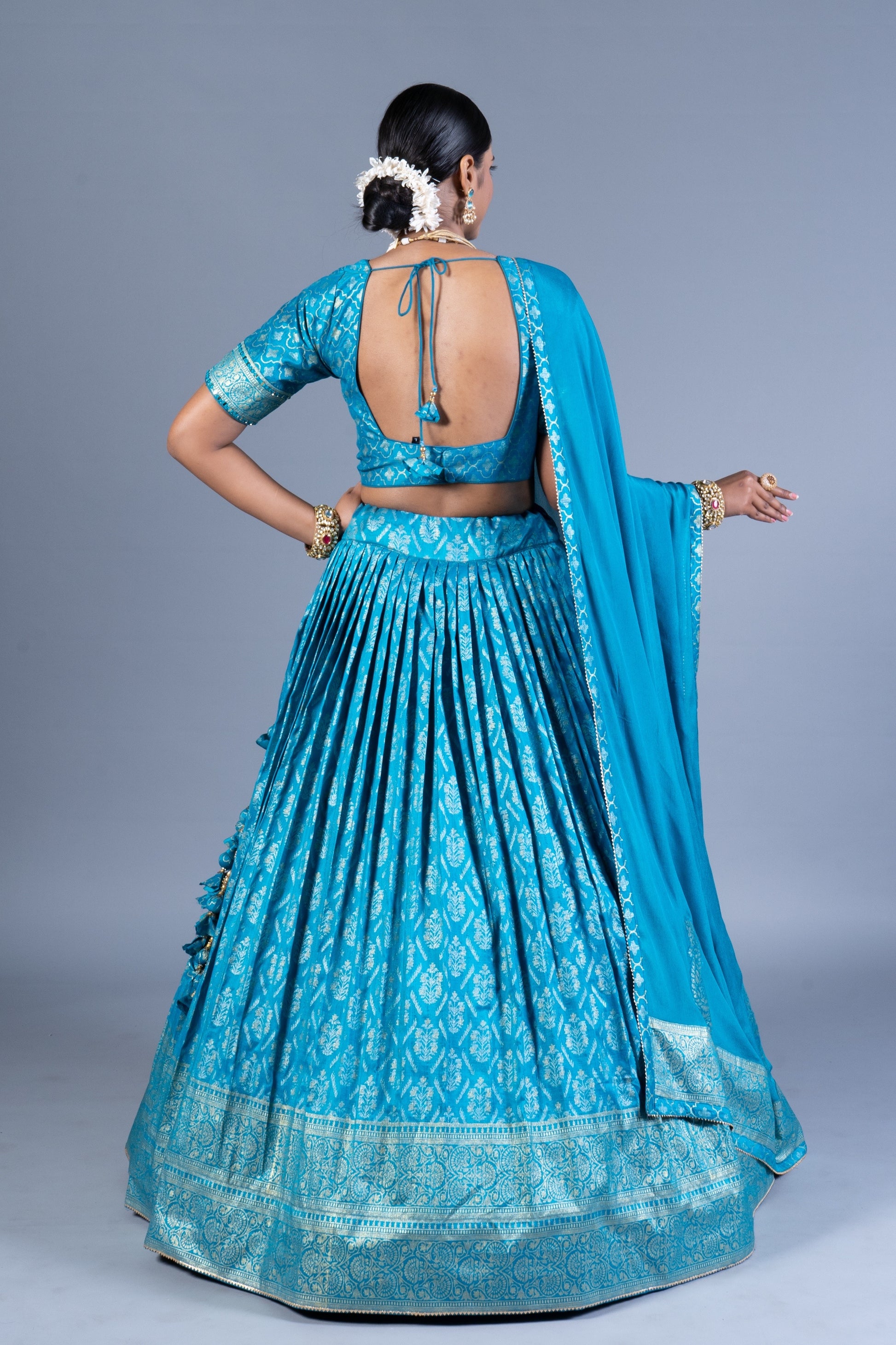 Turquoise Blue Patola Print Pleated Lehenga Set with Sequin Embroidered Blouse and Zari Border