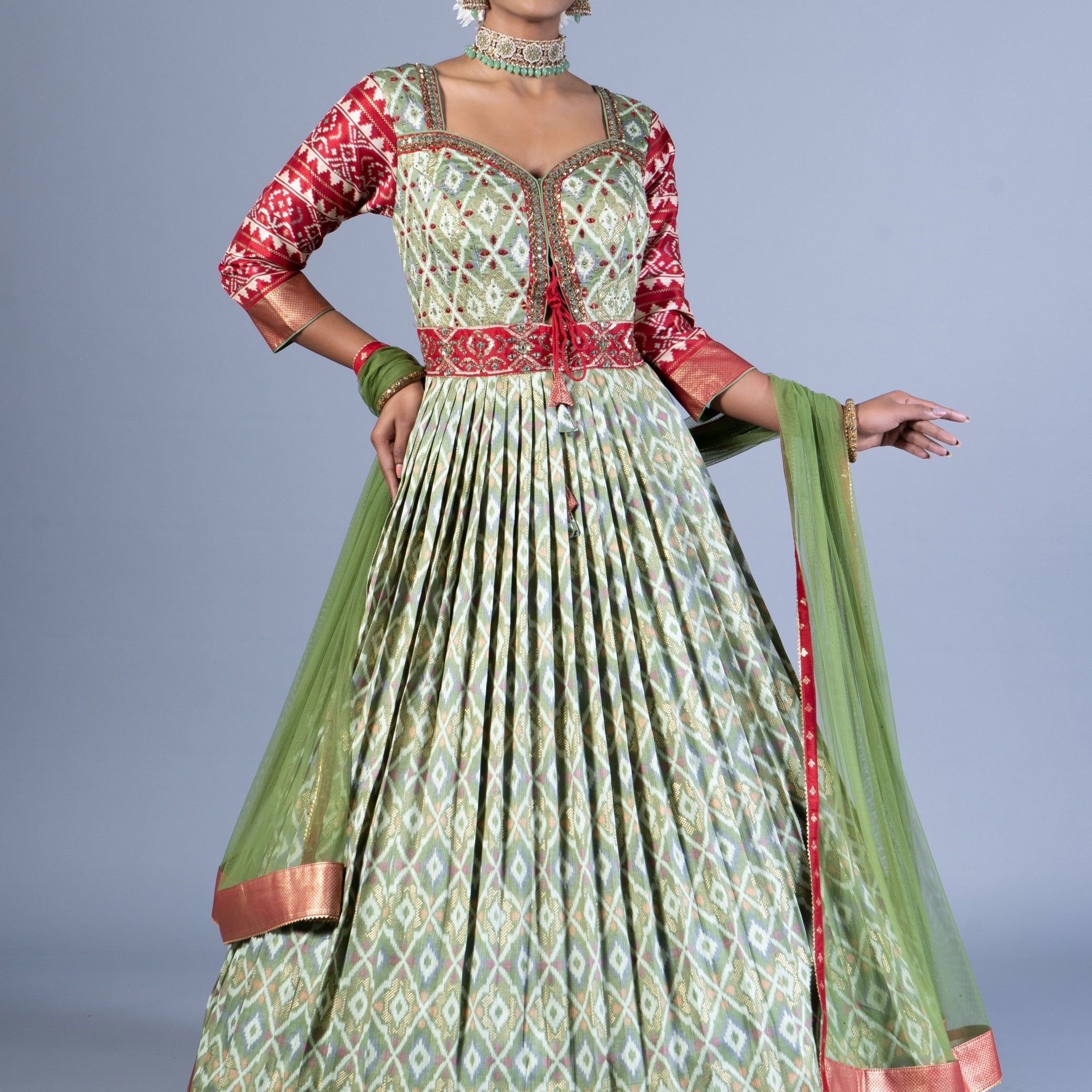 Royal Sage Green & Crimson Patola Silk Fusion Gown with Zari Border and Keyhole Back