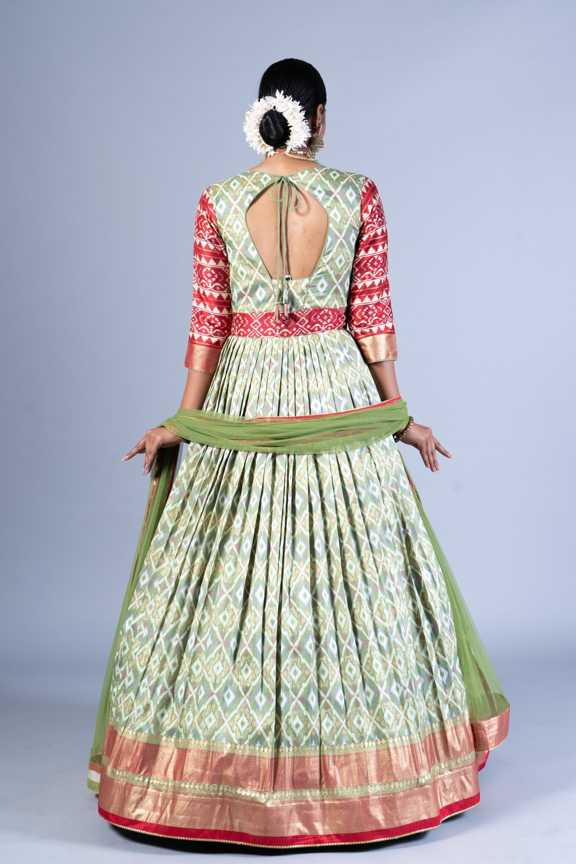Royal Sage Green & Crimson Patola Silk Fusion Gown with Zari Border and Keyhole Back