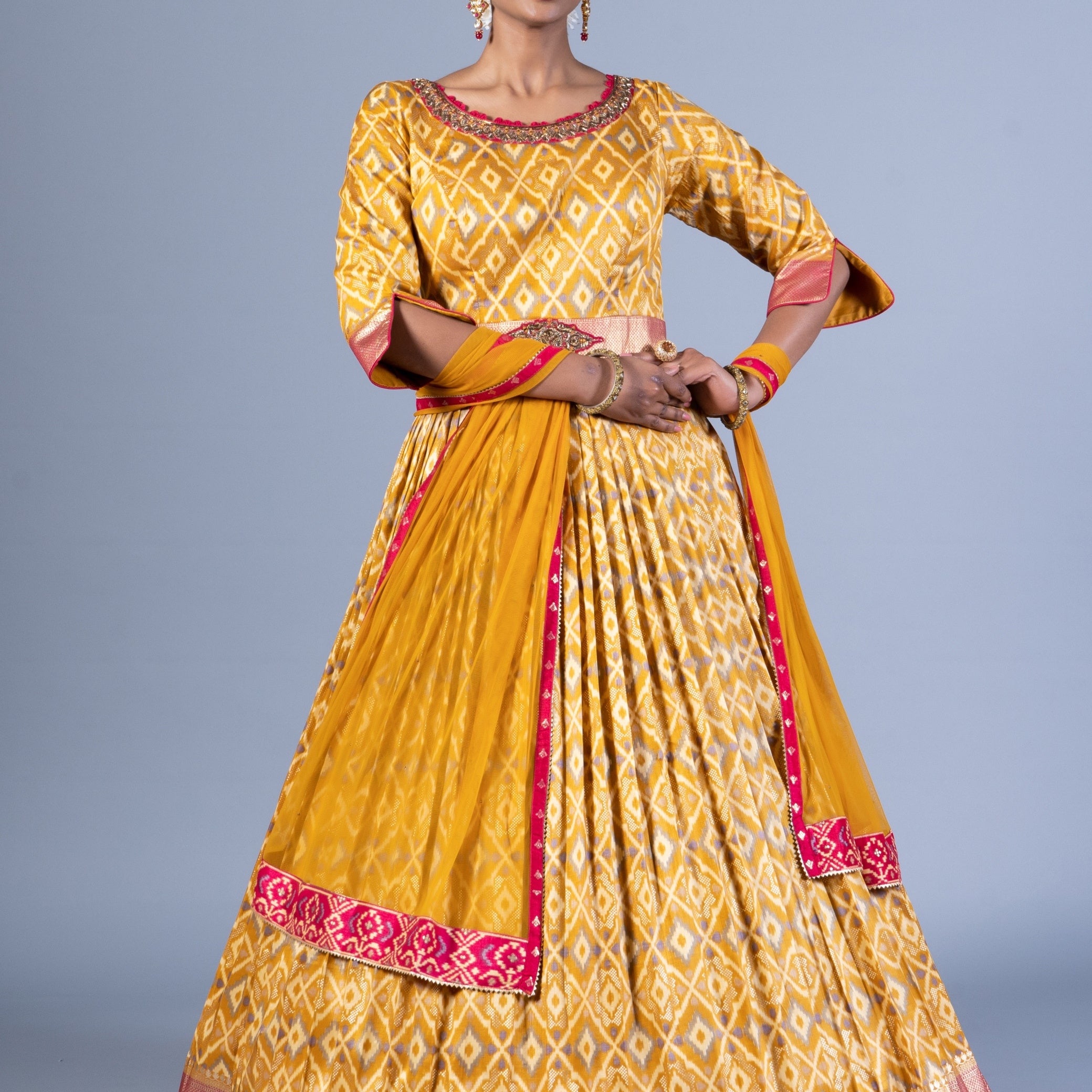 Radiant Mustard Yellow Patola Silk Gown with Embroidered Round Neck and Keyhole Back