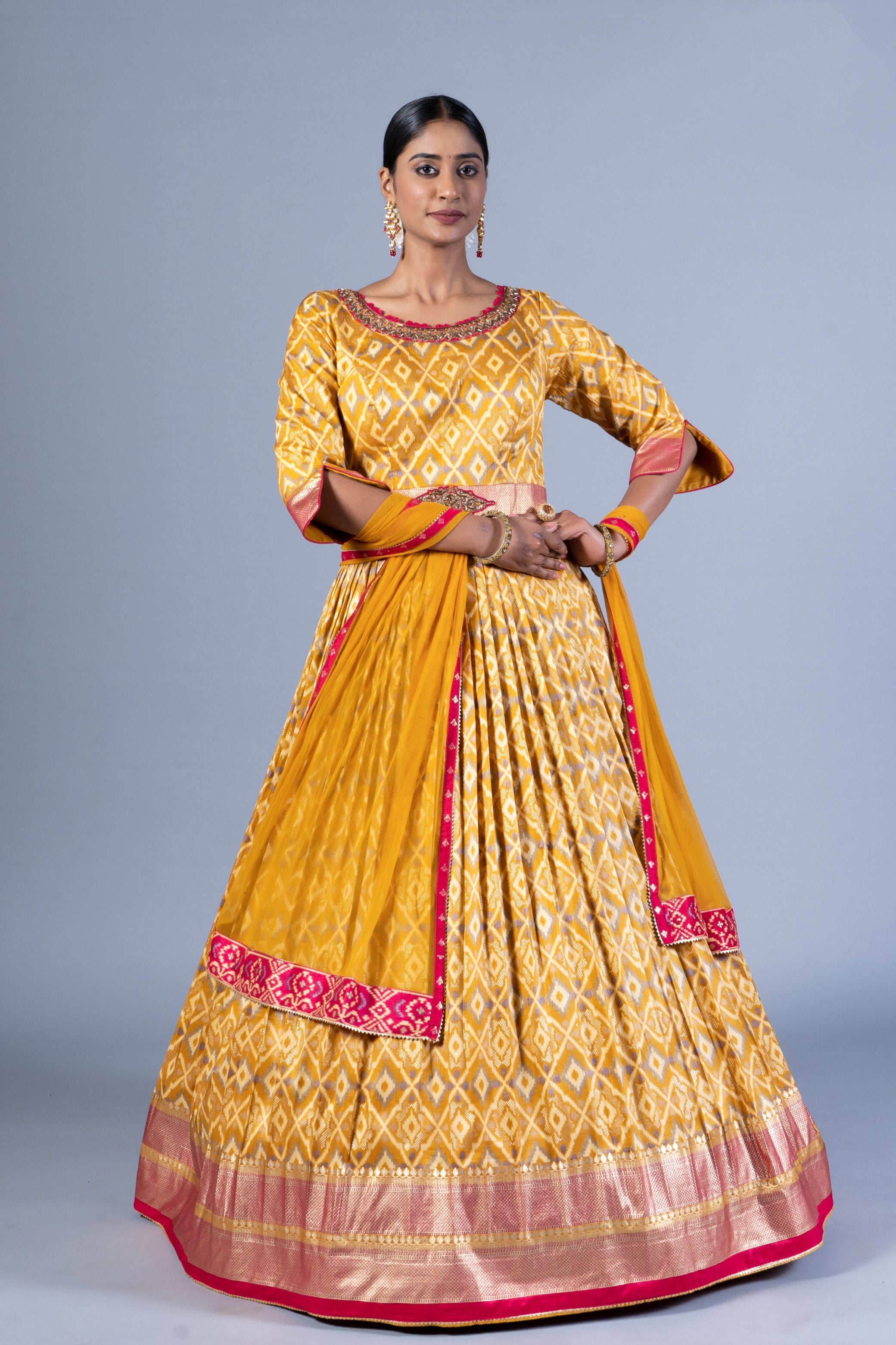 Radiant Mustard Yellow Patola Silk Gown with Embroidered Round Neck and Keyhole Back