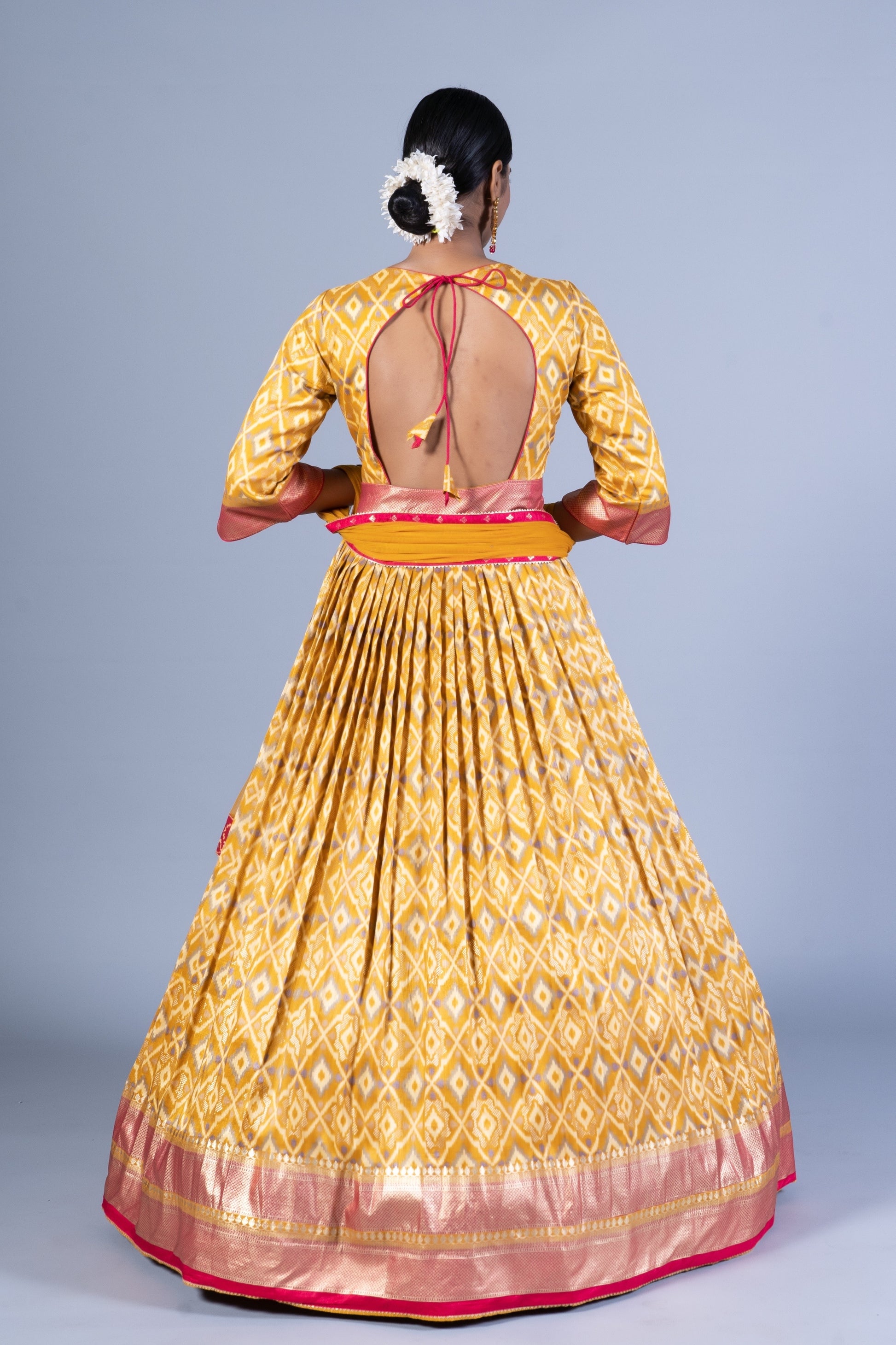 Radiant Mustard Yellow Patola Silk Gown with Embroidered Round Neck and Keyhole Back